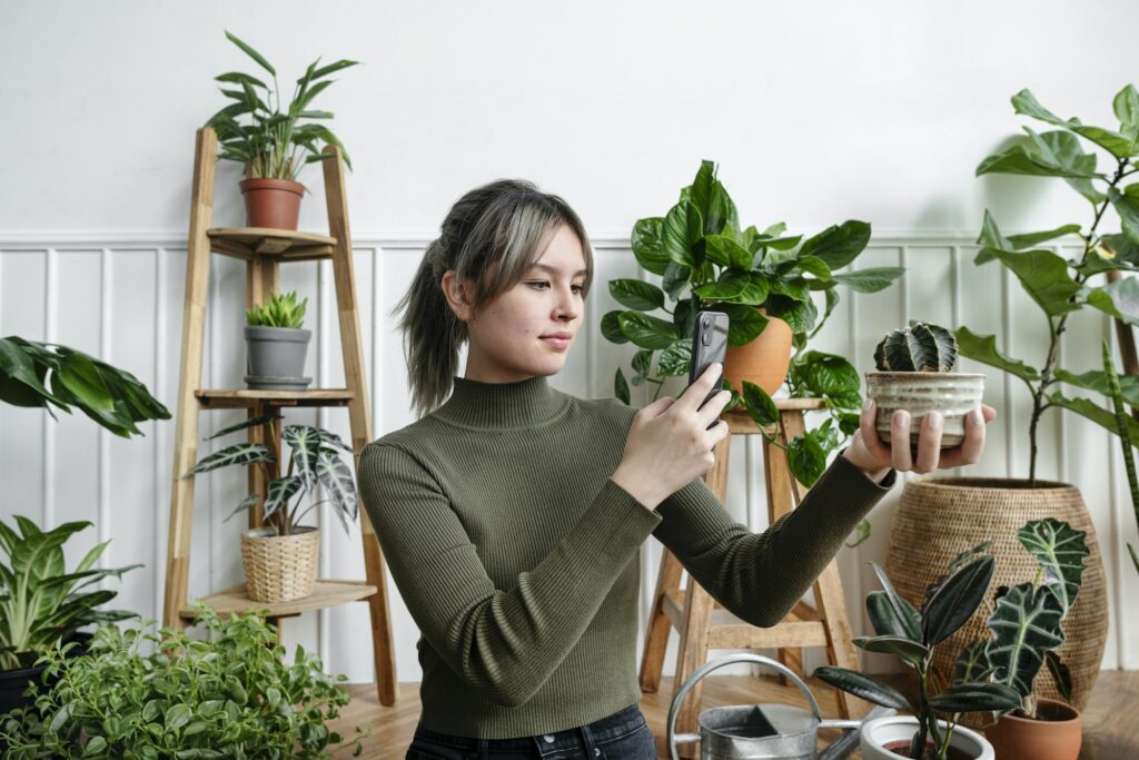 Woman taking a snapshot of her plant for social media